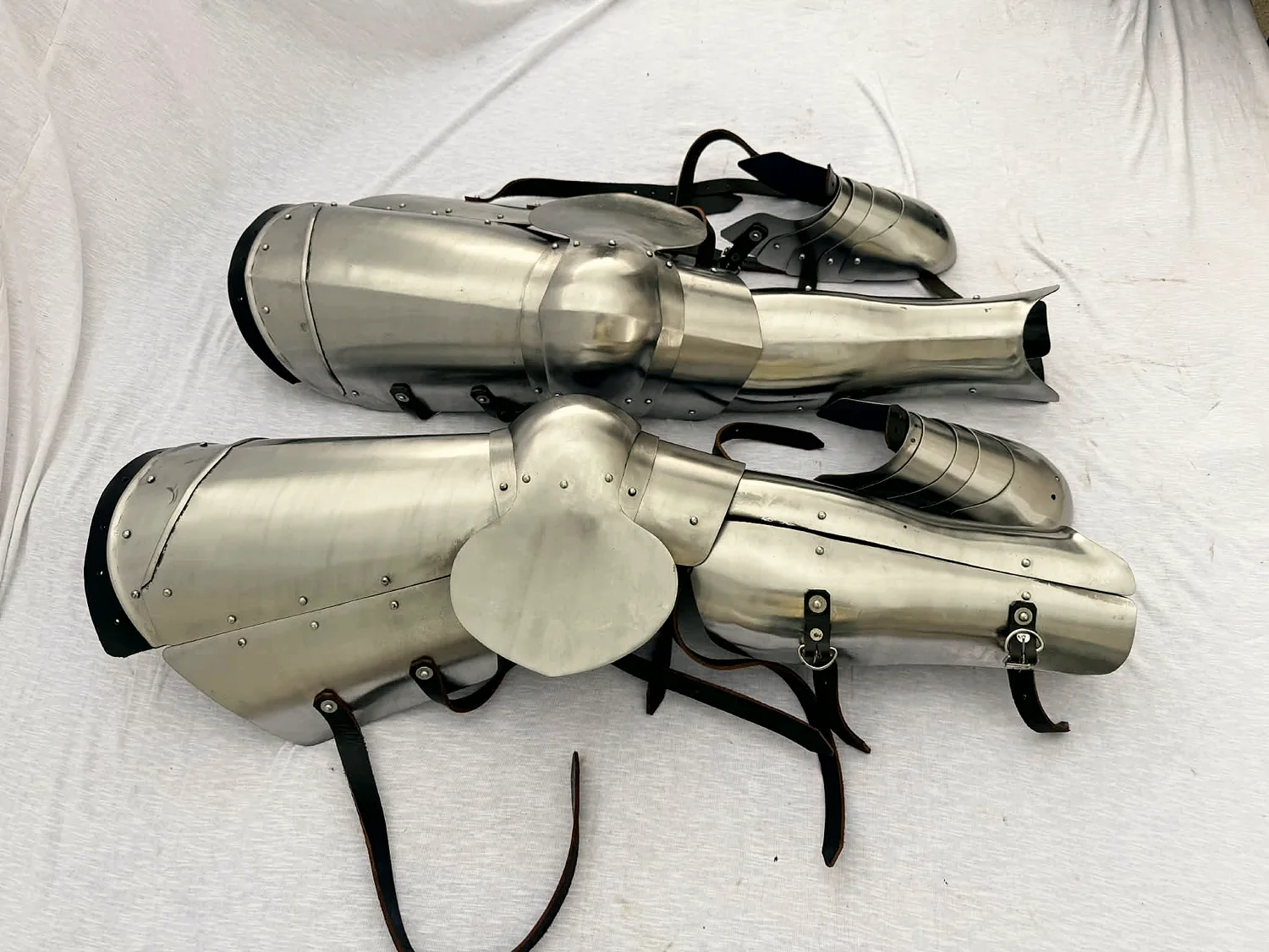 A complete pair of leg harnesses — cuisses, poleyns, greaves and sabatons